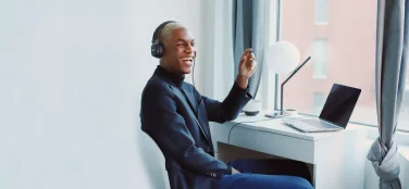 Man Sitting At Desk Laughing