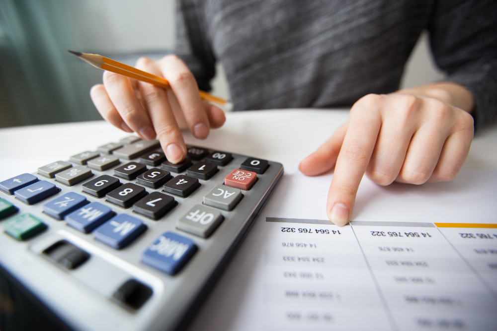 Closeup Of Accountant Hands Counting On Calculator (1)