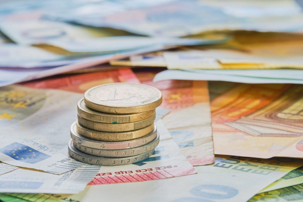 Euro Money Euro Currency Coins Stacked On Top Of Each Other In Different Positions Against The Background Of Euro Banknotes Business Finance Concept Business News Splash Screen Banner Mockup