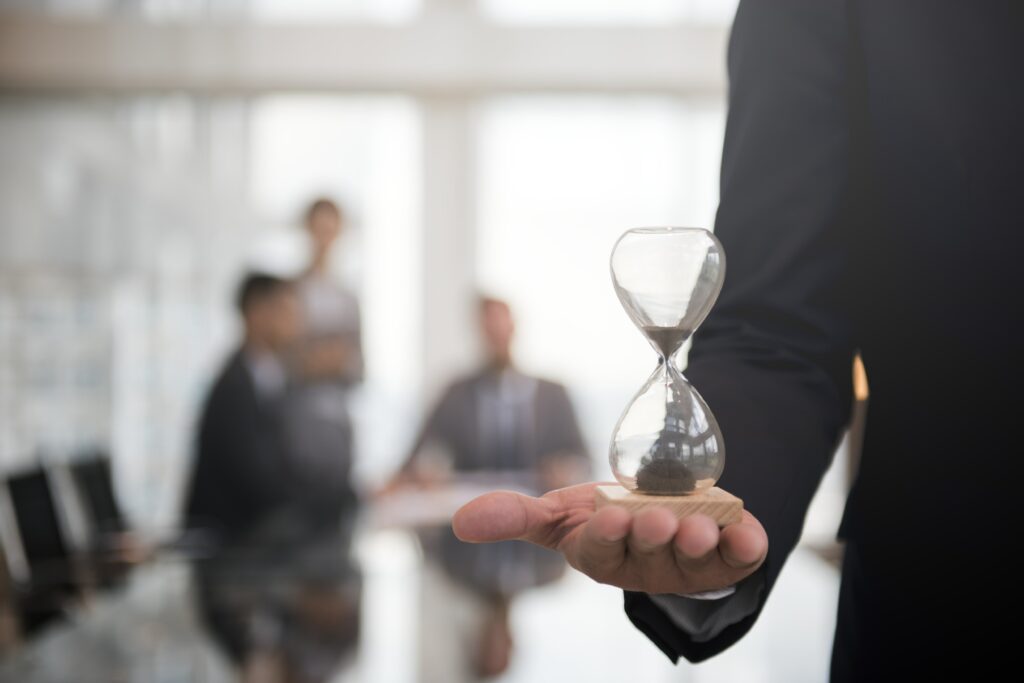 businessman holding hour glass means importance being time min
