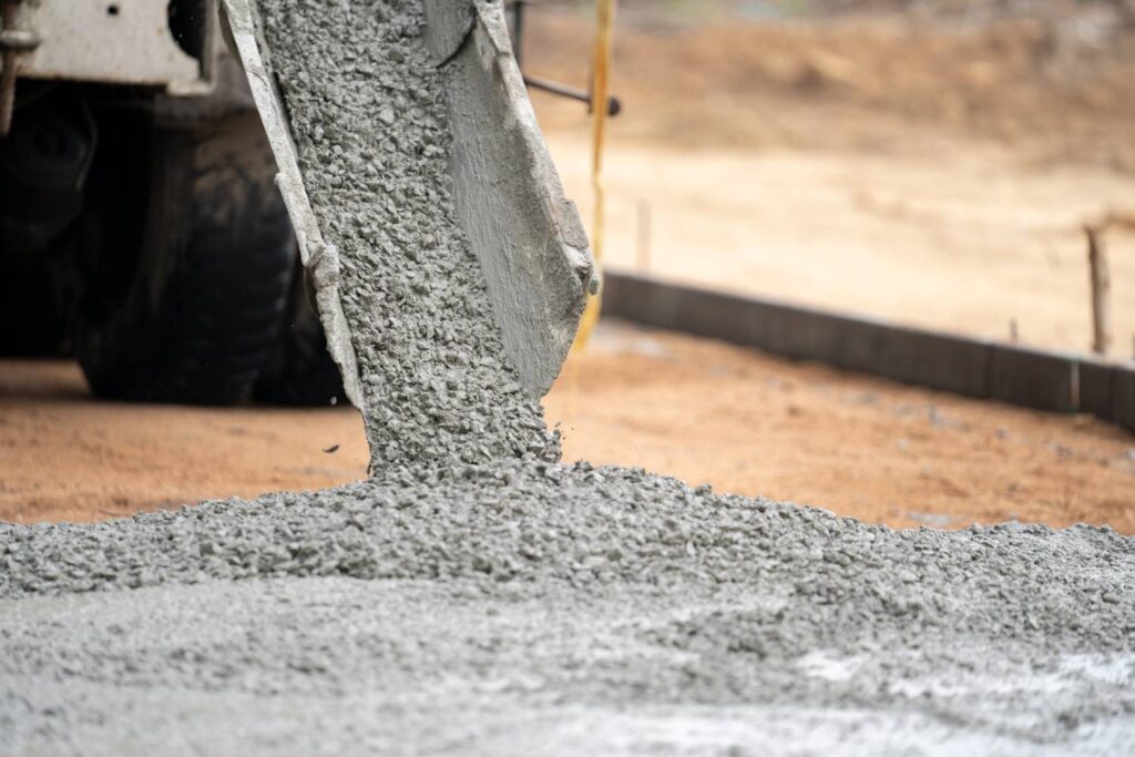 construction worker pouring wet concret road construction site