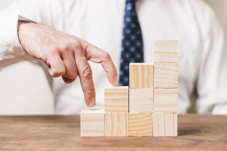 businessman using wooden pieces min